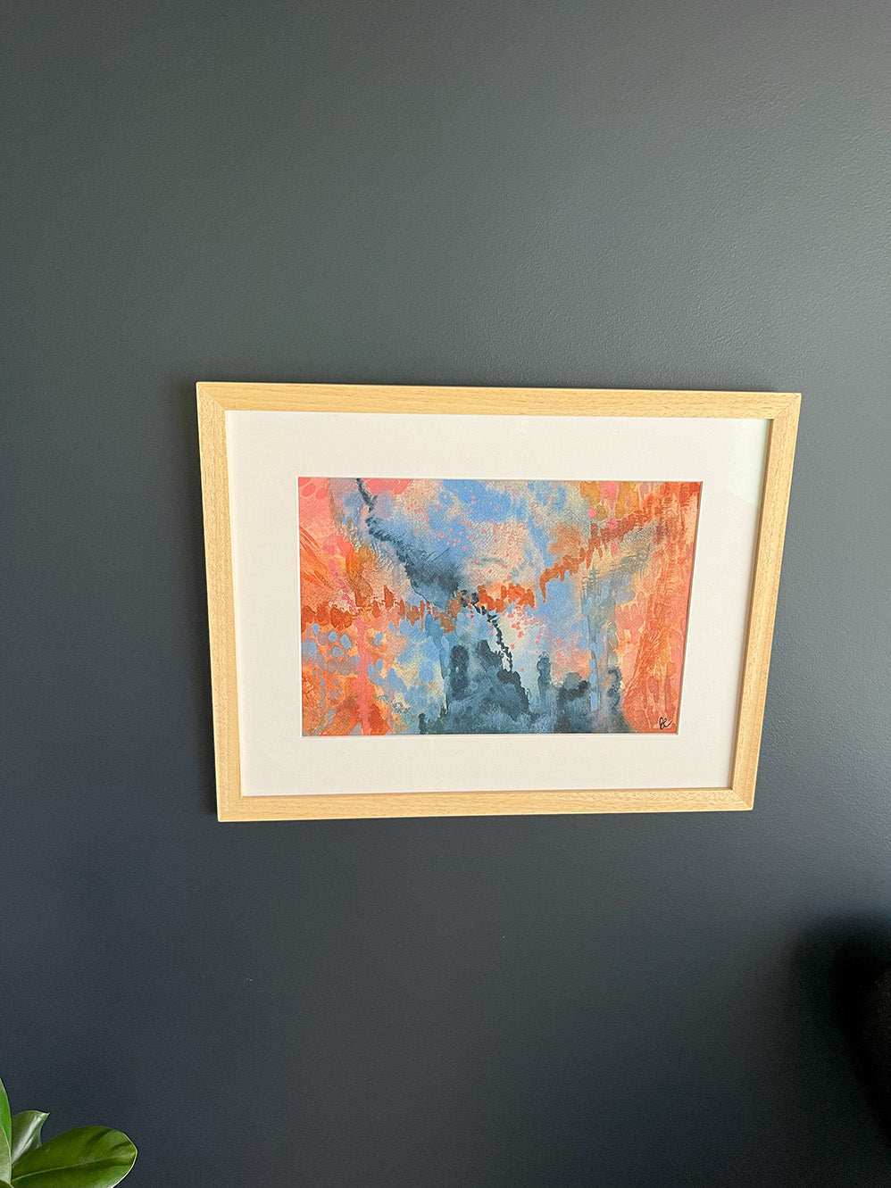 Framed Watercolour Abstract called Conundrum hanged on a dark blue wall