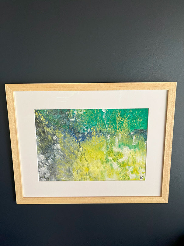  Framed Watercolour Abstract called Tenacity hanged on a dark blue wall