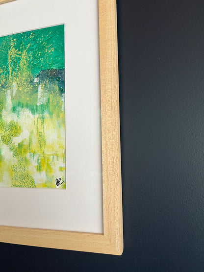 Close-up of Framed Watercolour Abstract called Tenacity hanged on a dark blue wall